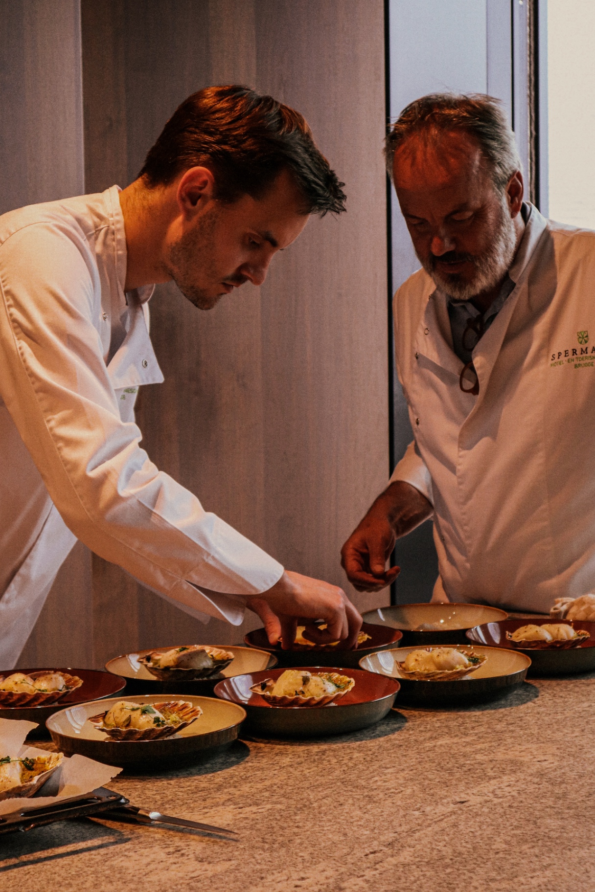 Chefs plating a course